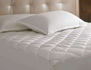 Sheraton Mattress Pad Quilted white comforter and pillows on bed.